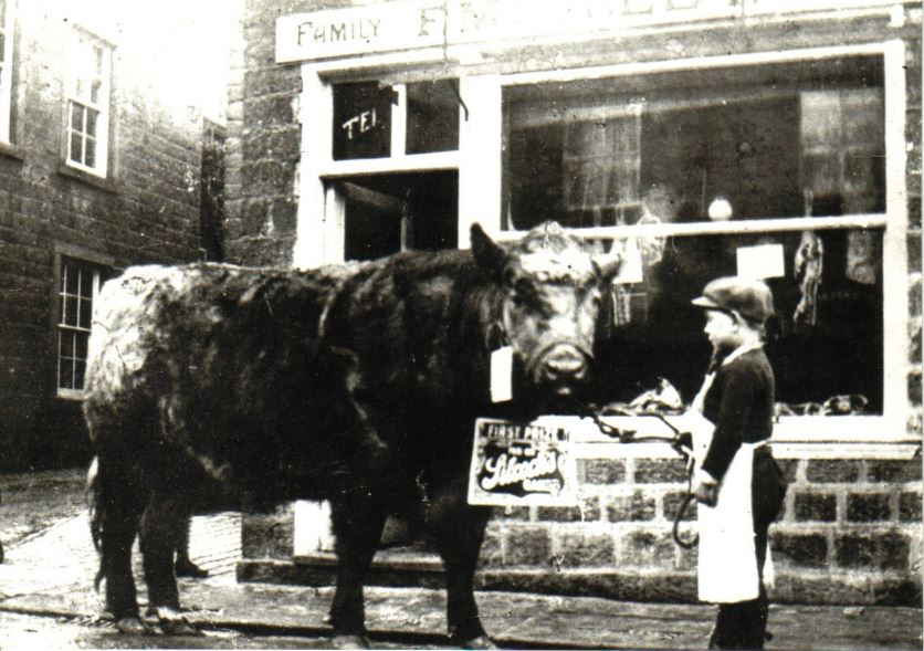 Sidney Midgley holding prize bullock, 91 Main Street, Burley in Wharfedale